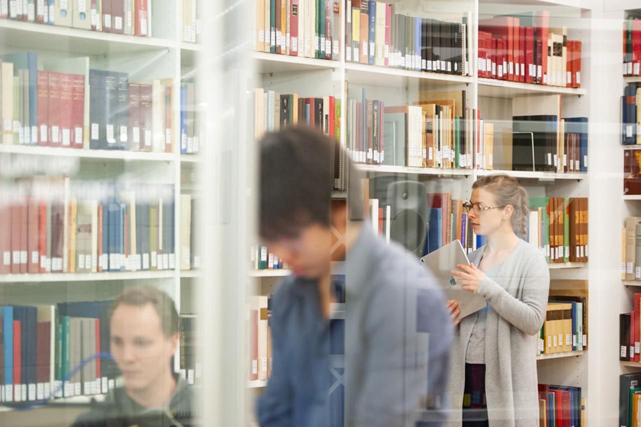 Drei Personen in der Bibliothek der Hoschule für Musik